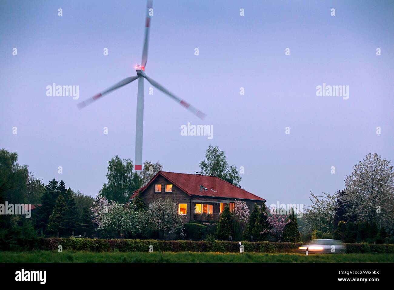 Residential house in front of the wind energy plant in Wolbeck near Münster in Germany, where about 1200 households in the district can be supplied. Stock Photo