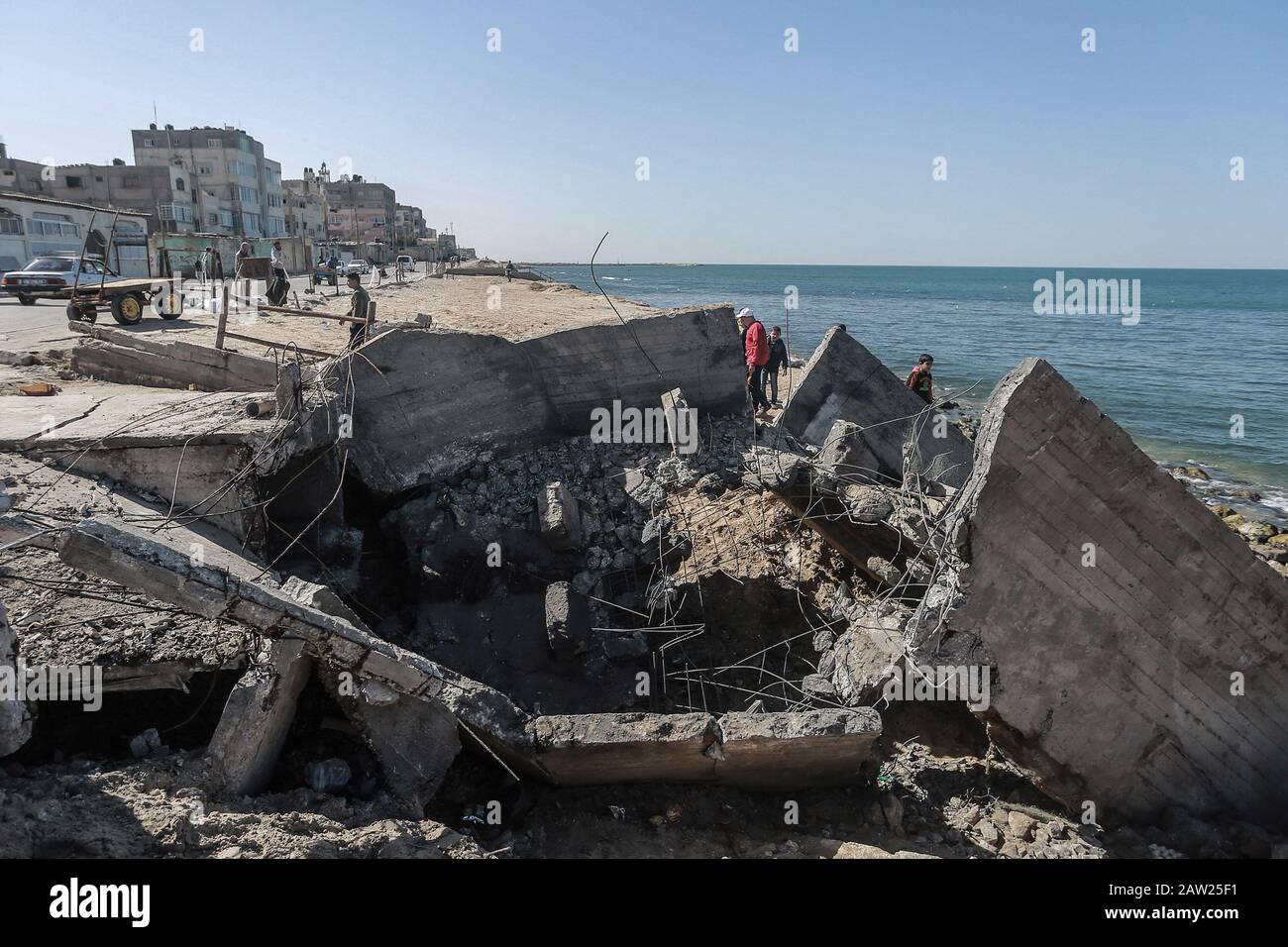 06 February 2020, Palestinian Territories, Gaza City: Palestinians inspect a site after it was targeted by Israeli airstrike at Al-Shati refugee camp in Gaza City. Photo: Mohammed Talatene/dpa Stock Photo