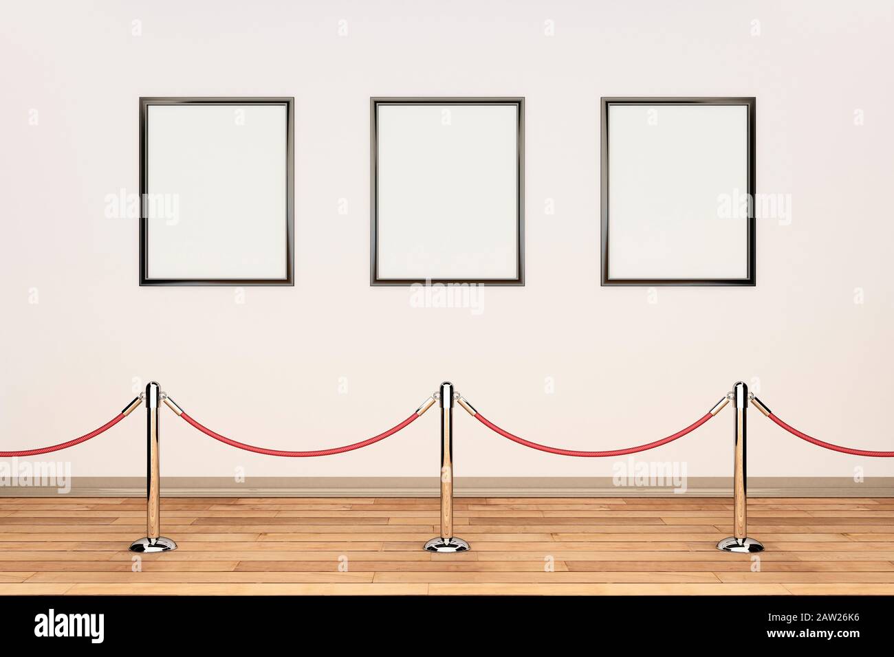 Three blank picture frames in a row on a cream wall in an art gallery with barrier rope and posts Stock Photo