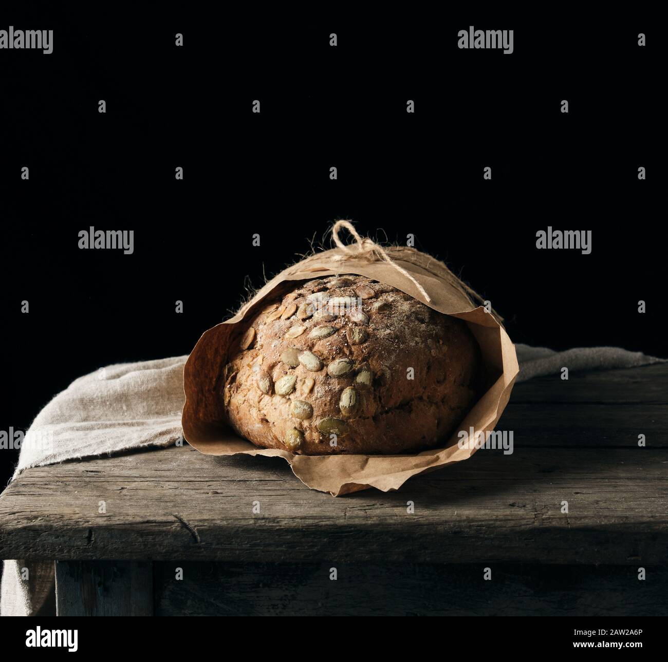 baked oval bread made from rye flour with pumpkin seeds, black background Stock Photo Alamy