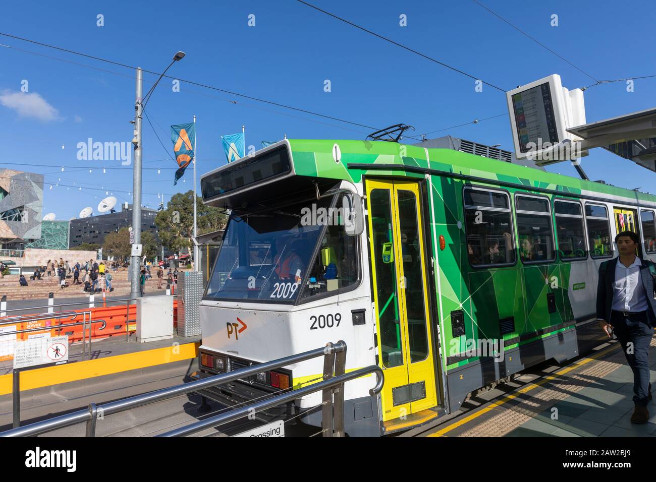 Melbourne trams and passengers on Princes bridge beside flinders street station,Melbourne city centre,Victoria,Australia Stock Photo