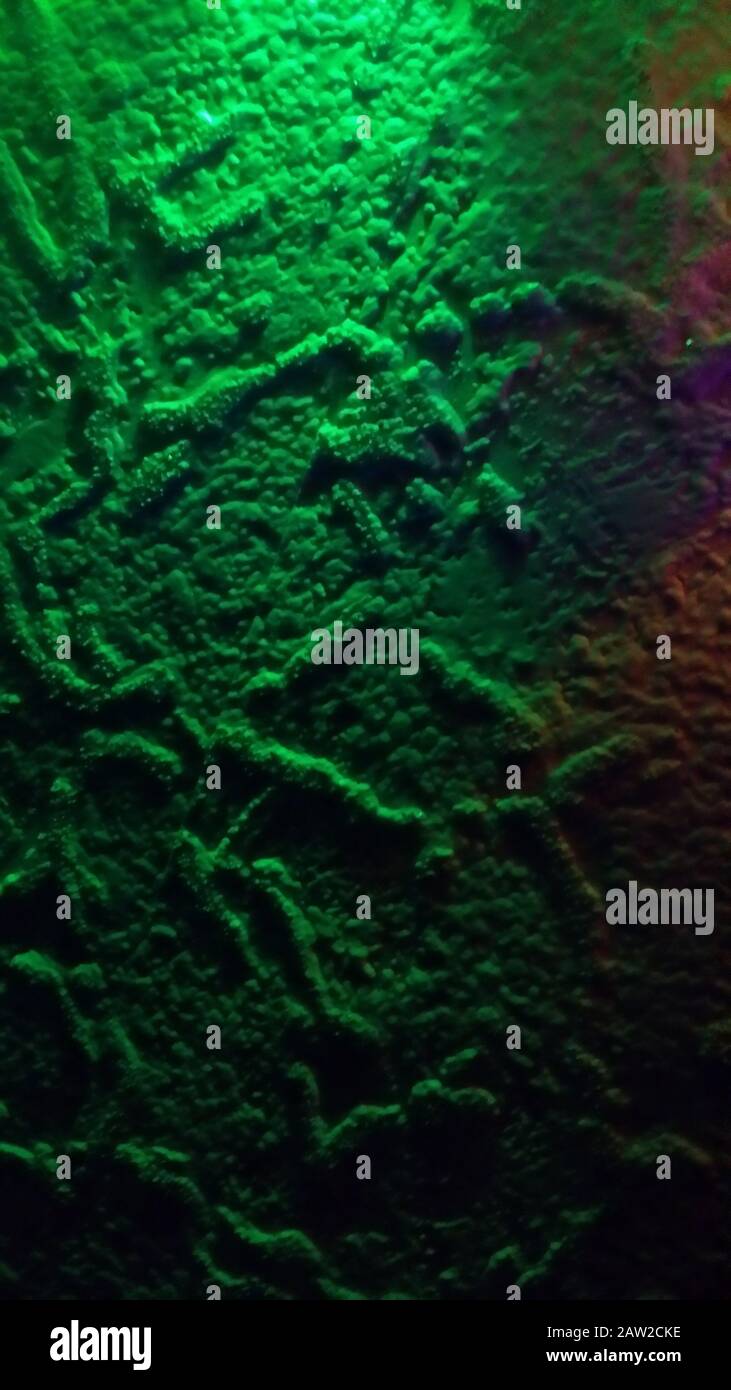 Painted wall background in green neon light Stock Photo
