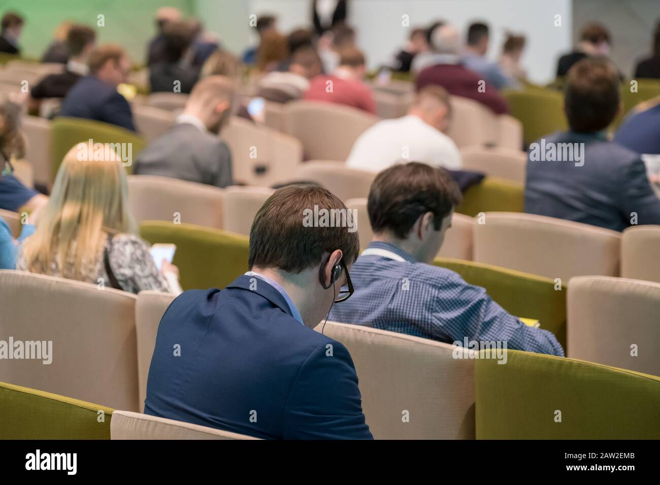 Conference attendees sitting listening hi-res stock photography and ...