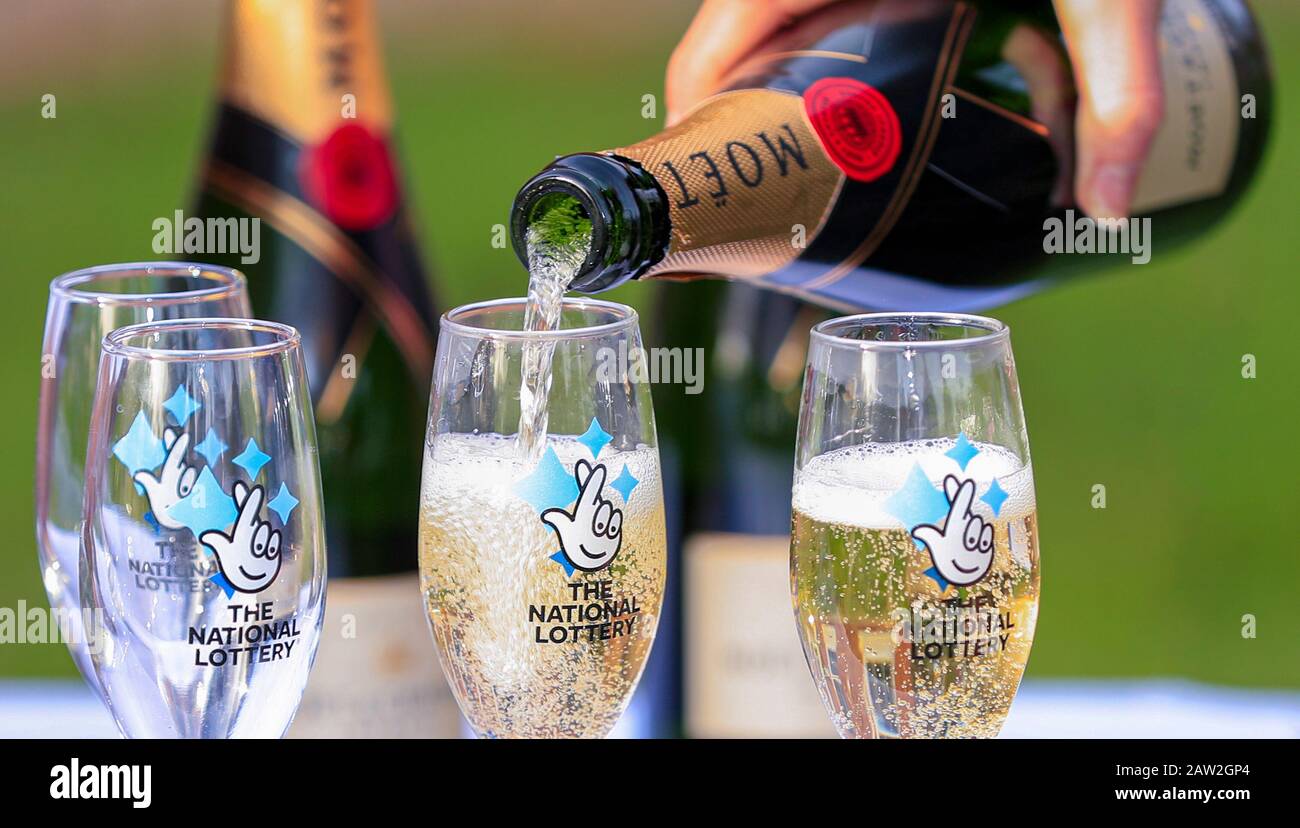 A bottle of Moet & Chandon champagne with The National Lottery branded  champagne flutes, on a white table cloth during a lottery winners photocall  at the Mercure Haydock Hotel in Haydock. PA