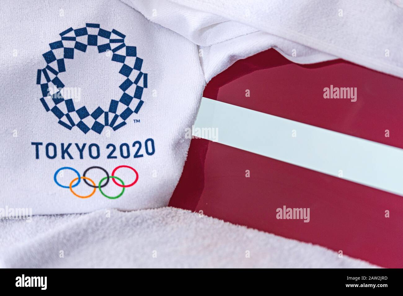 TOKYO, JAPAN, FEBRUARY. 4, 2020: Latvia National flag, official logo of summer olympic games in Tokyo 2020. White background Stock Photo