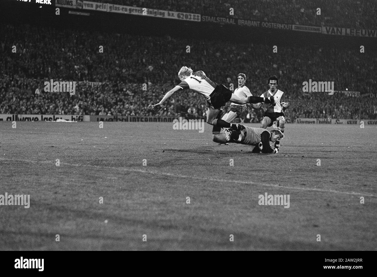 Feyenoord - Ajax 4-0  Petur Petursson (13) dives over keeper Piet Writers go Date: September 29, 1979 Location: Rotterdam, South Holland Keywords: goalies, sports, soccer person Name: Petursson, Petur, Writers, Piet Institution Name: Feyenoord Stock Photo