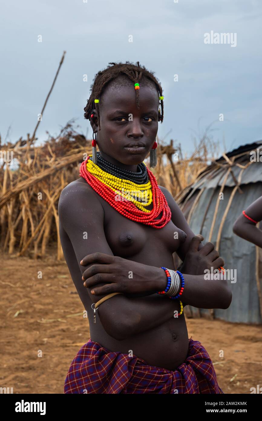 Omorate, Ethiopia - Nov 2018: Young woman of Dassanech tribe posing, wearing tradition colorful necklaces. Omo valley Stock Photo