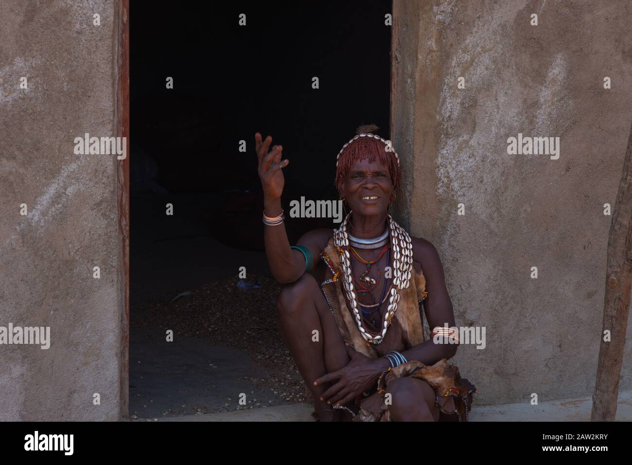 Turmi, Ethiopia - Nov 2018: Hamer tribe lady sitting in front of the house. Omo valley Stock Photo