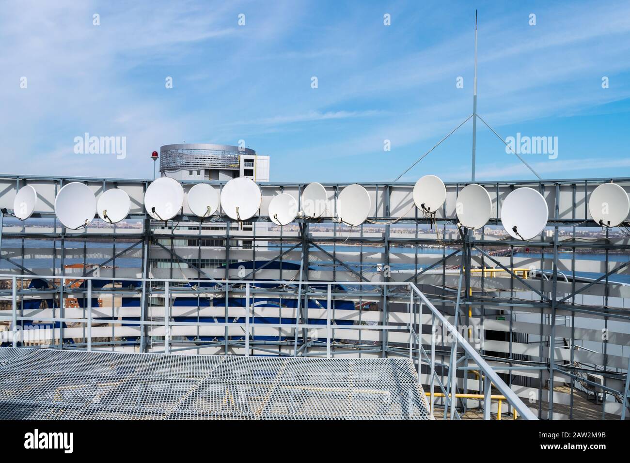 Satellite antennas are on the roof of the building. TV station with a lot of receiving devices. Telecommunication equipment of the telecentre Stock Photo