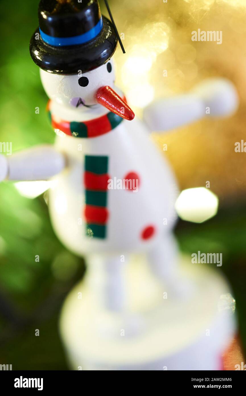 Wooden toy snowman tree decoration hanging on a Christmas tree Stock Photo