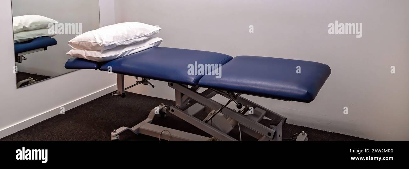 Adjustable treatment bed with pillows in a physiotherapist clinic Stock