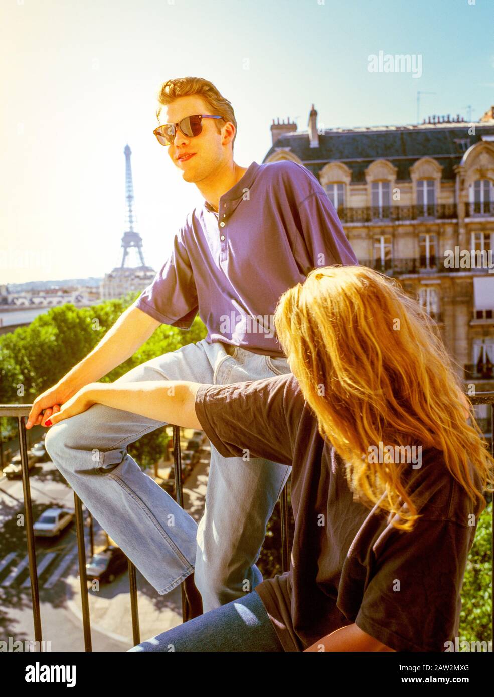 Paris Hotel Balcony with Young Couple and Eiffel Tower Stock Photo