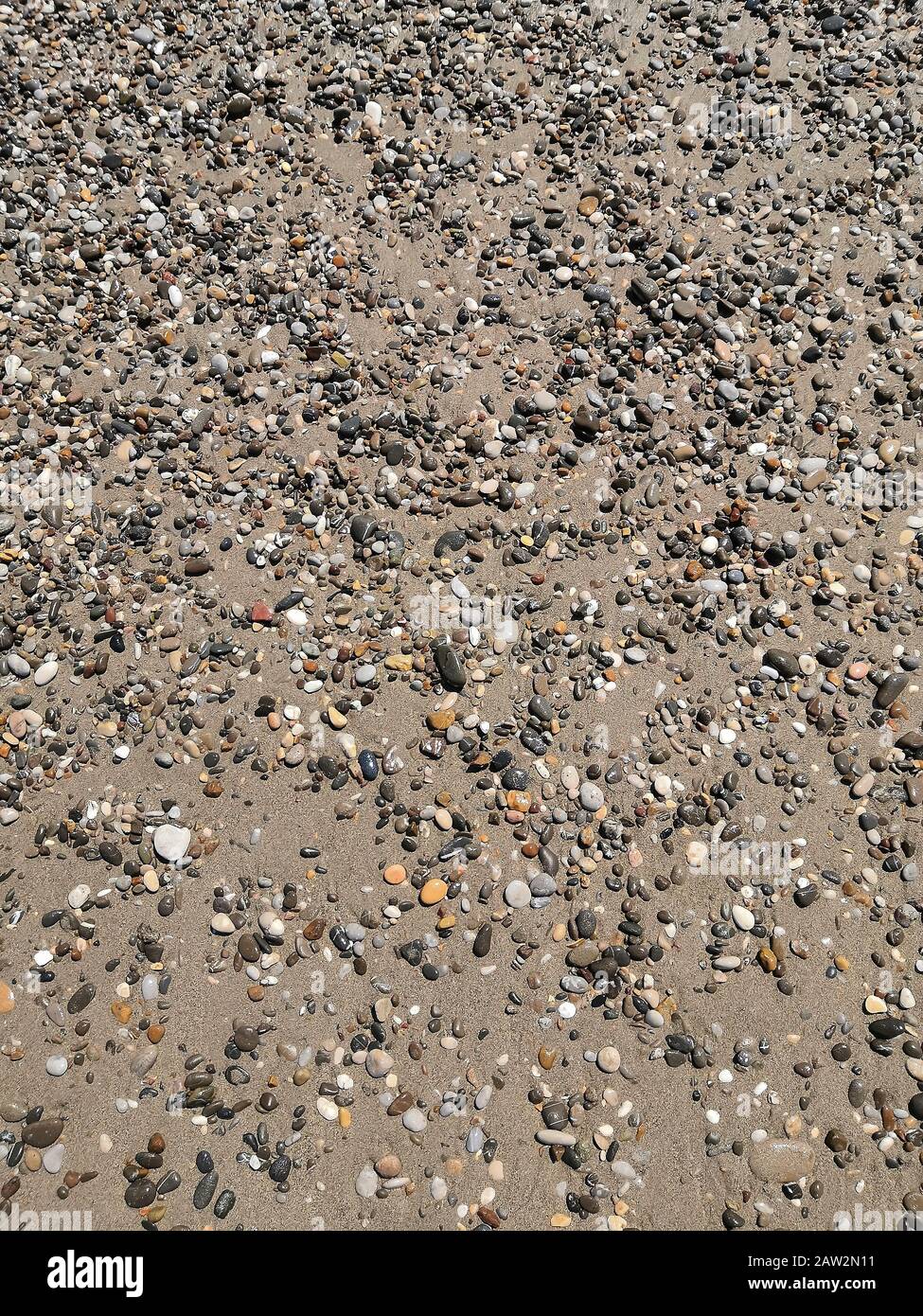 Background image: small sea pebbles on the beach Stock Photo