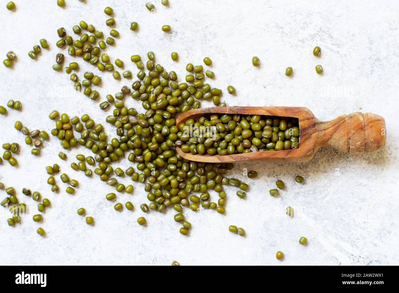 Dried mung beans with a spoon on a white background  top view Stock Photo