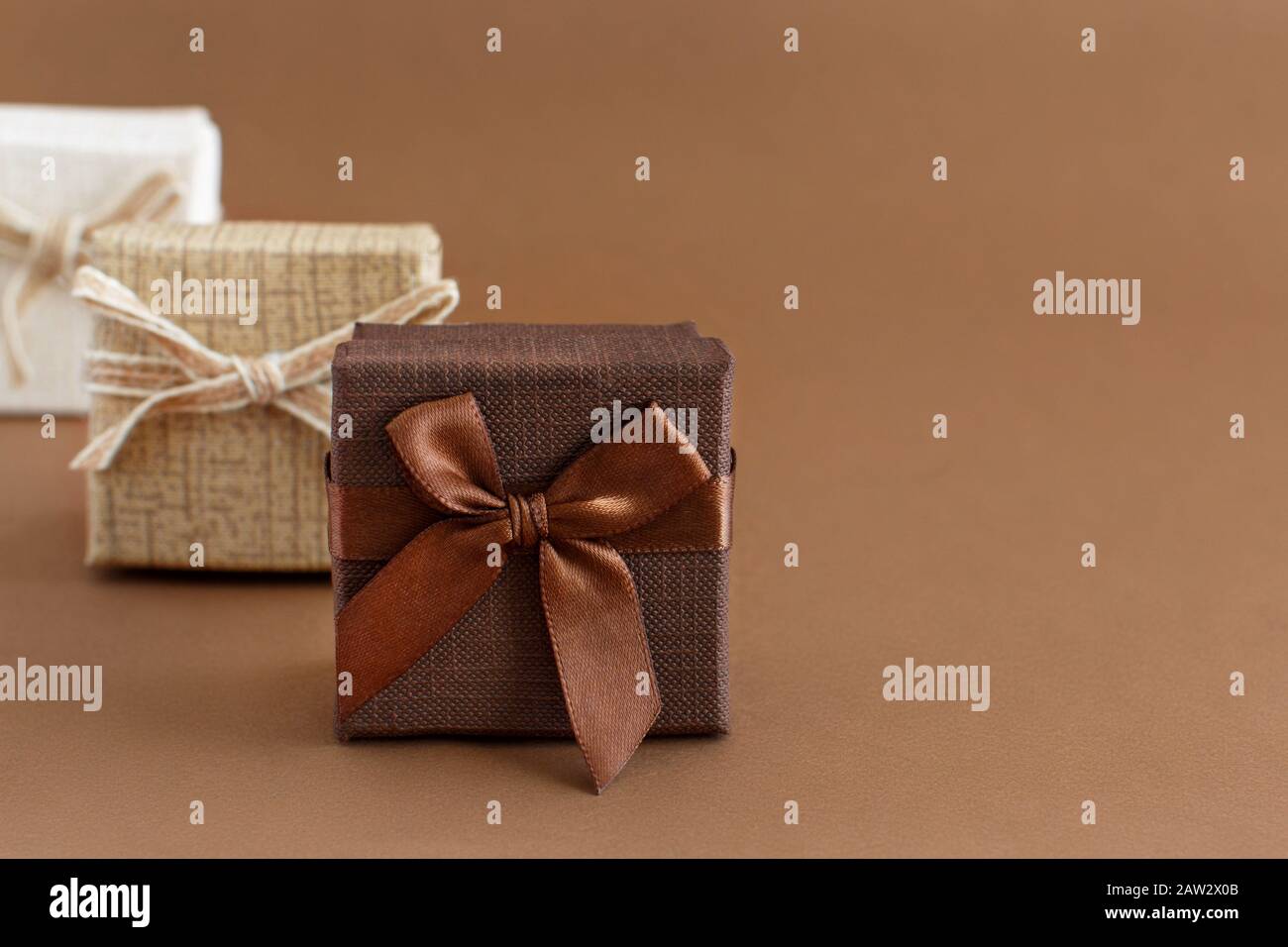 Brown tones gift boxes on a brown background close up Stock Photo