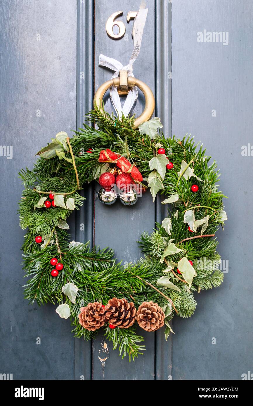 A home-made Christmas wreath on the front door of a residential property in North London, UK Stock Photo