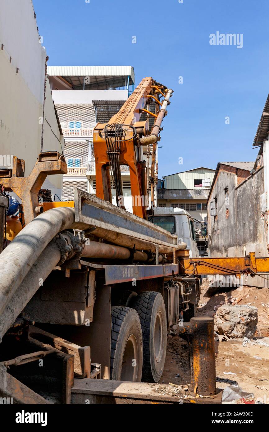 A small pile driver is set up on the construction site of a new building on a vacant lot in the city center of Kampong Cham, Cambodia. Stock Photo