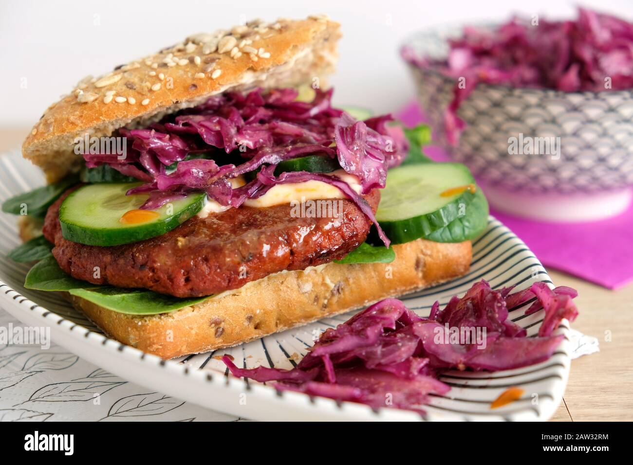 Vegan baharat burger with red cabbage salad. Burger is made with vegetable minced meat from the Danish brand Naturli. Stock Photo