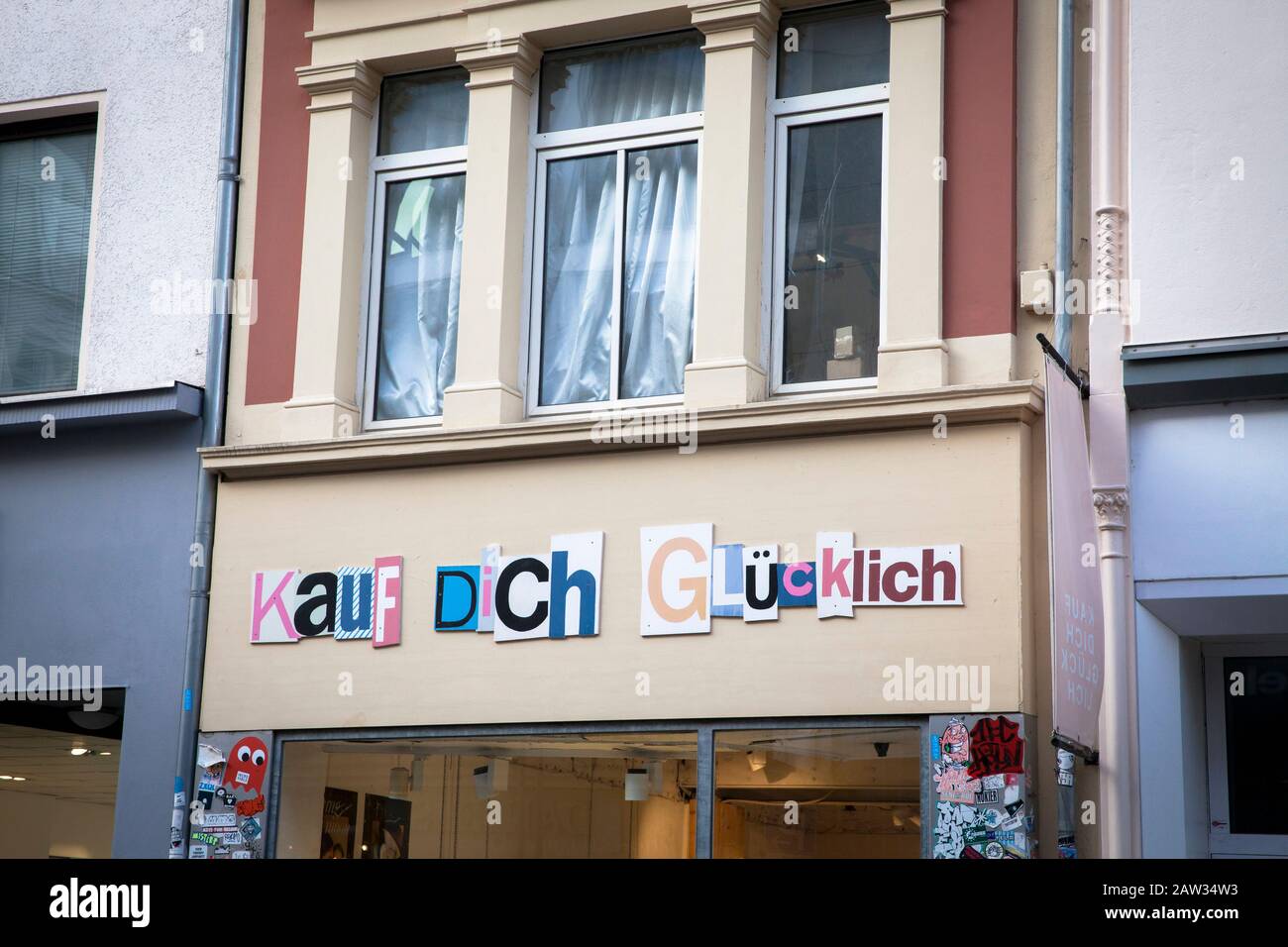 fashion store Kauf Dich Glücklich (buy yourself happy) on shopping street Ehrenstrasse, Cologne, Germany.  Modegeschaeft Kauf Dich Glücklich in der Eh Stock Photo