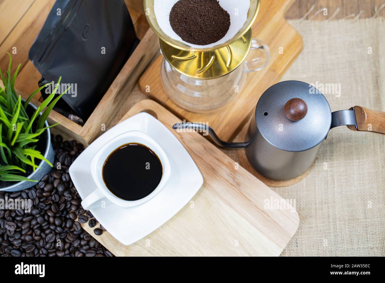 Grind the coffee beans inside the filter at the coffee level to prepare the drip coffee just like the coffee in the cup. Stock Photo