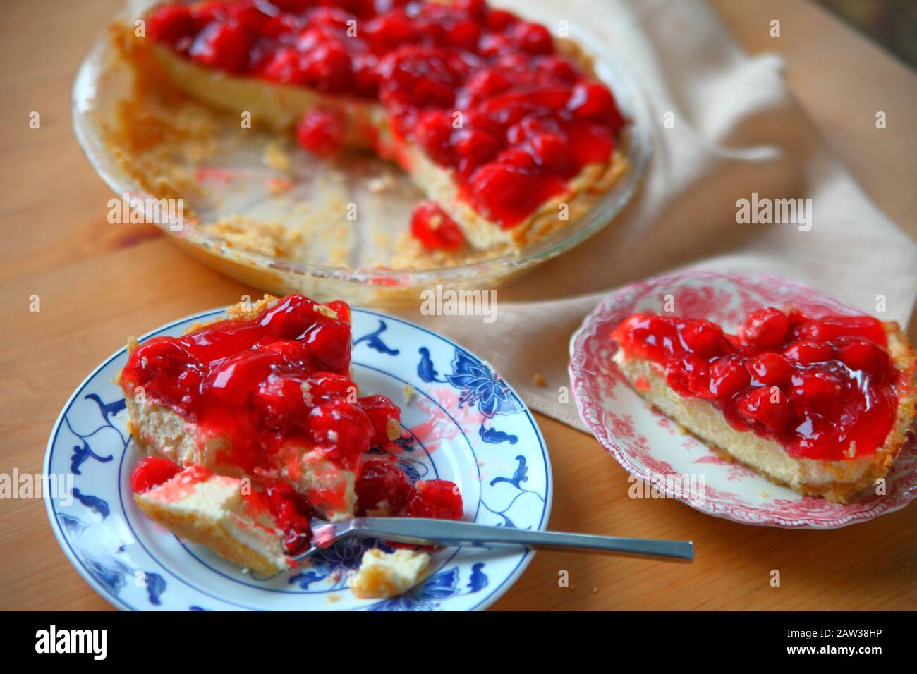 A cherry cream cheese pie served on decorative dishes Stock Photo