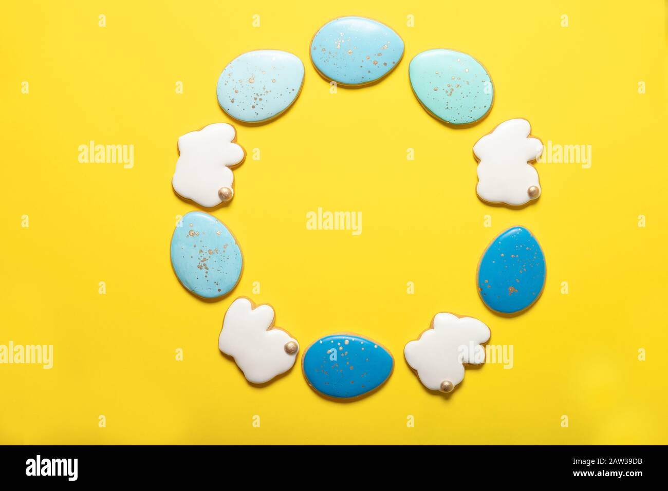 Easter cookies on a yellow background. Easter bunnies. Top view. Place for text. Easter eggs. Stock Photo