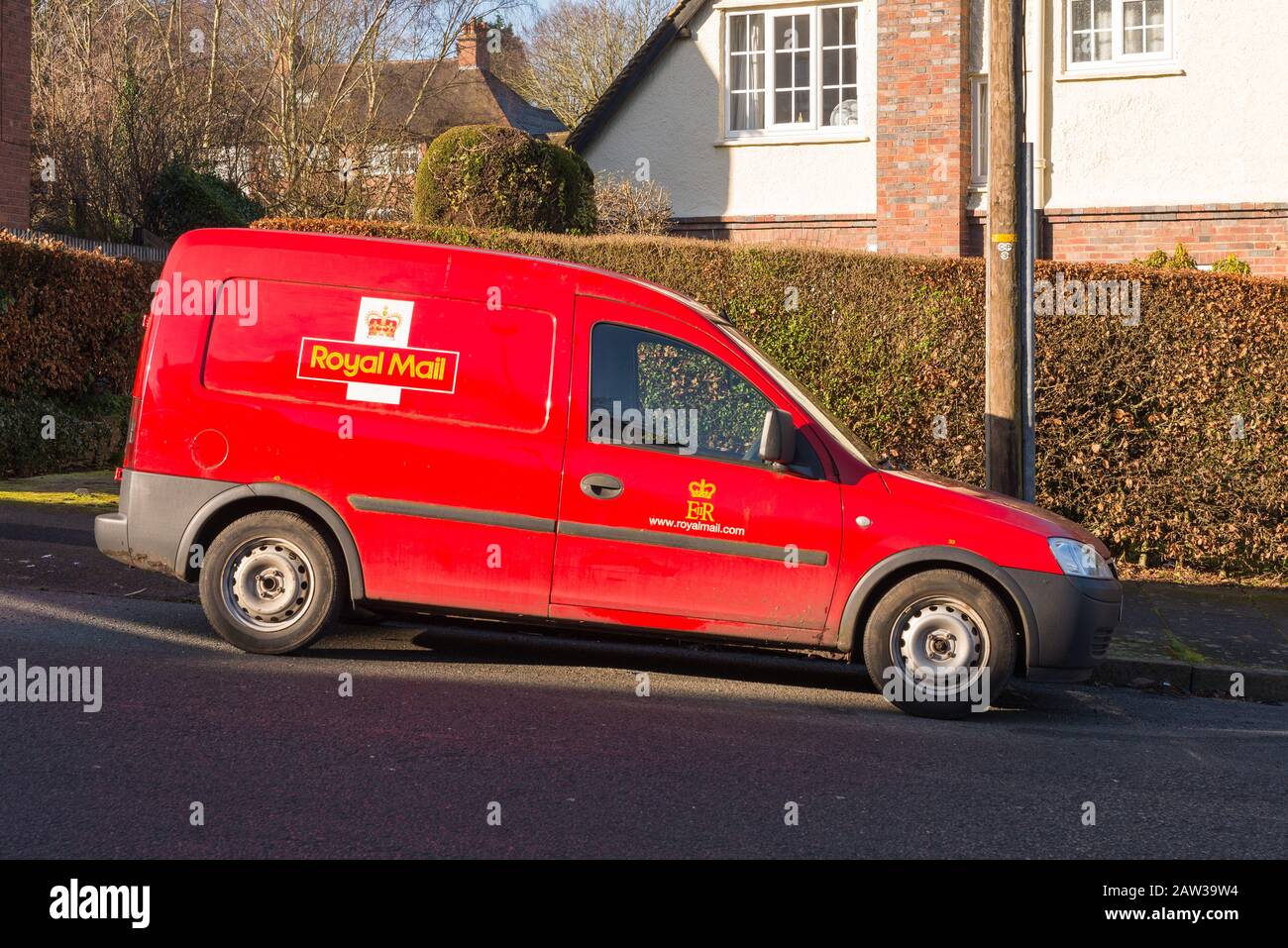 Red Royal Mail postal van parked on the Moor Pool Estate which is a garden suburb in Harborne, Birmingham and is a conservation area. Stock Photo