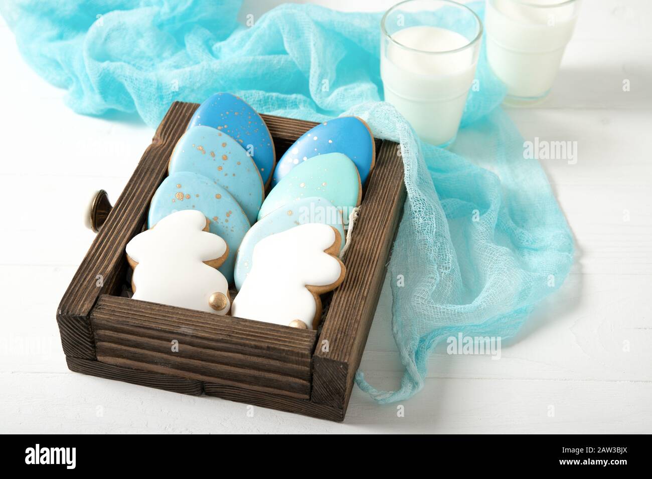 Easter cookies in a drawer. Glass of milk. Easter eggs. Easter bunnies. Stock Photo