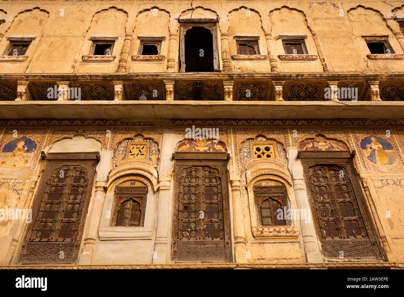India, Rajasthan, Shekhawati, Mandawa, decorated haveli, jettied upper floor with wooden window shutters Stock Photo