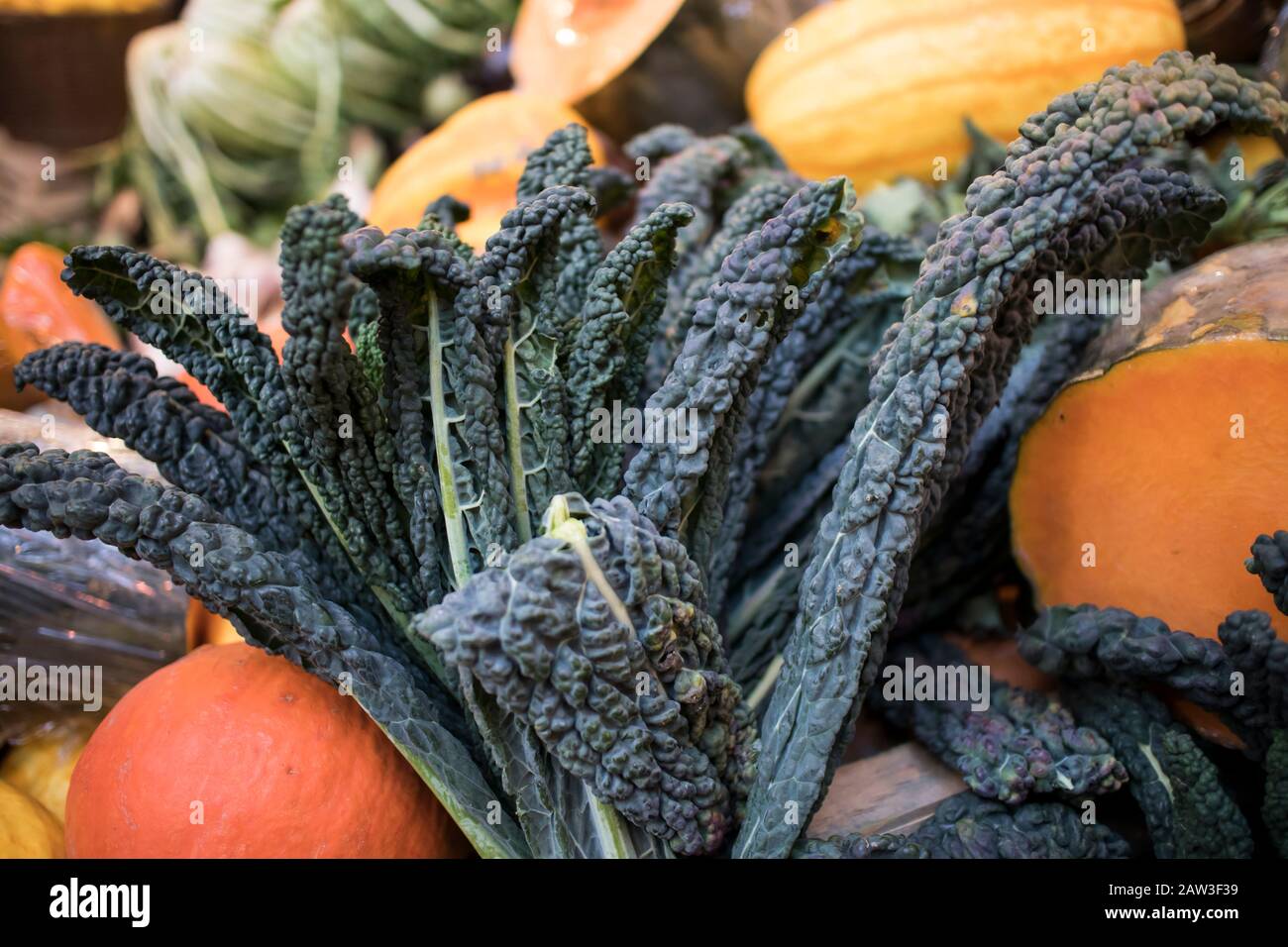 Different types of vegetables and salads on the counter at Borough Market. Interior of a vegetable shop Stock Photo