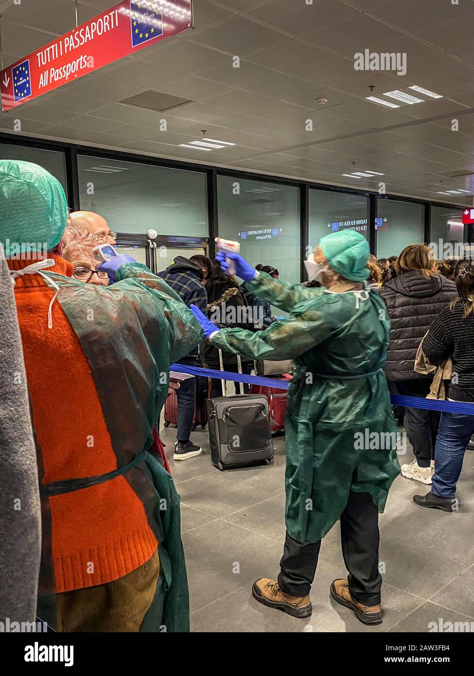 6th February 2020.  Tourists arriving at Bergamo airport, Italy being scanned by staff with electronic thermometers because of the coronavirus outbreak Stock Photo