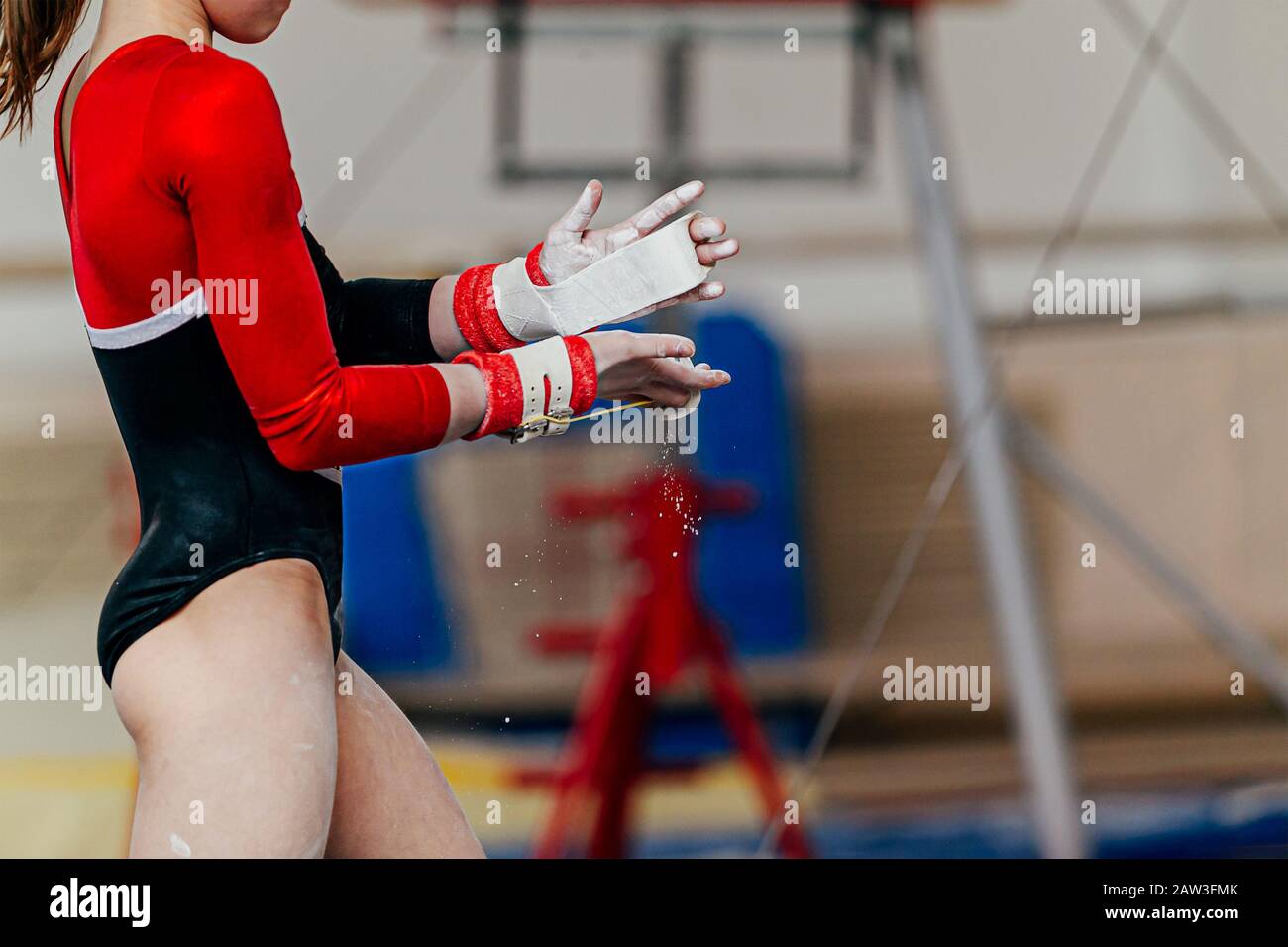 girl gymnast in gymnastics hand grips and gym chalk Stock Photo Alamy