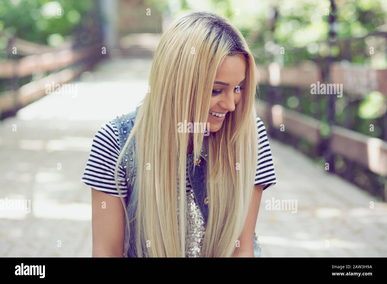 beautiful stylish blonde girl in yellow tights and jeans looking away  isolated on brown Stock Photo - Alamy