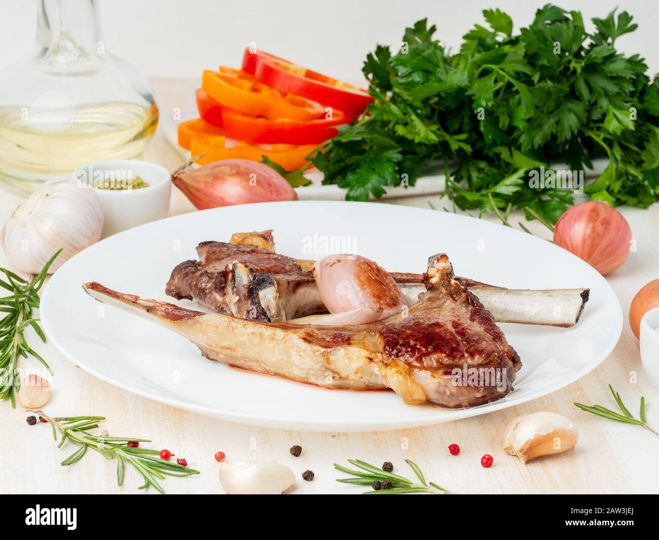 fat lamb fried ribs on white plate with vegetable and seasoning on