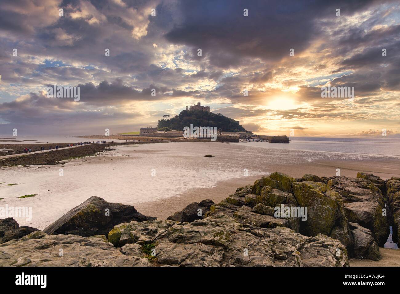 A view of Saint Michaels Mount island and tidal causeway at low tide from Marazion  in Cornwall Stock Photo