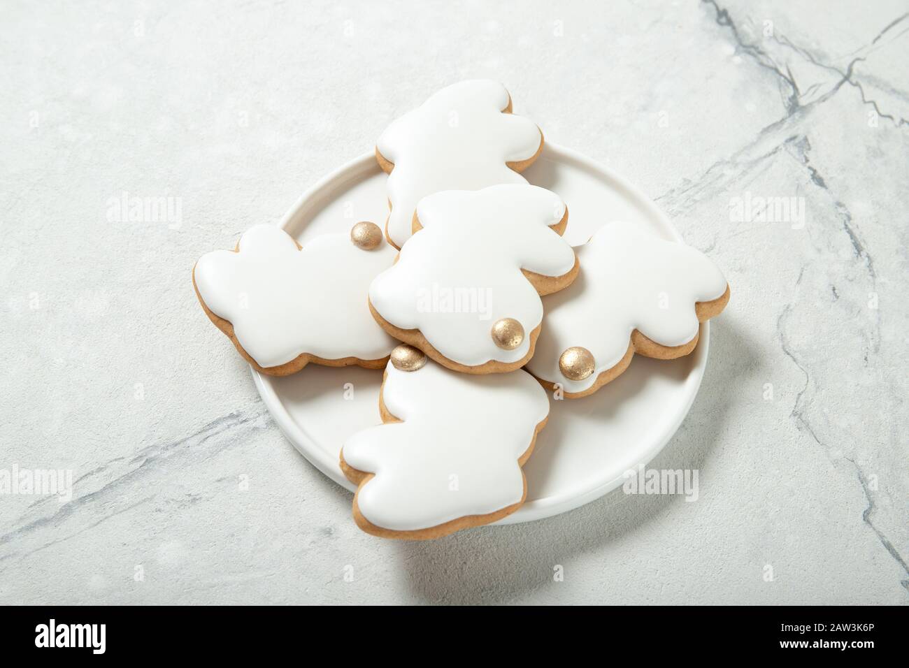 Easter cookies in a plate on a concrete background. Easter bunnies. Place for text. Top view. Close-up. Stock Photo