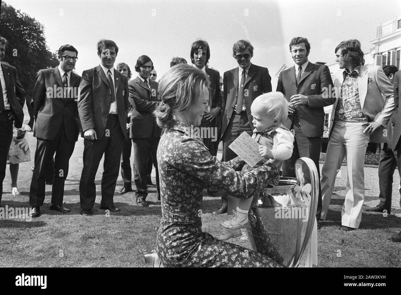 Reception of the football team Ajax by Queen Juliana at Soestdijk Palace  Princess Irene puts prince Carlos Jr. in the cup. Date: June 3, 1971 Location: Soestdijk, Utrecht (province) Keywords : princes, princesses, sports, football, soccer Person Name: Carlos Jr., prince, Irene (princess Netherlands) Stock Photo
