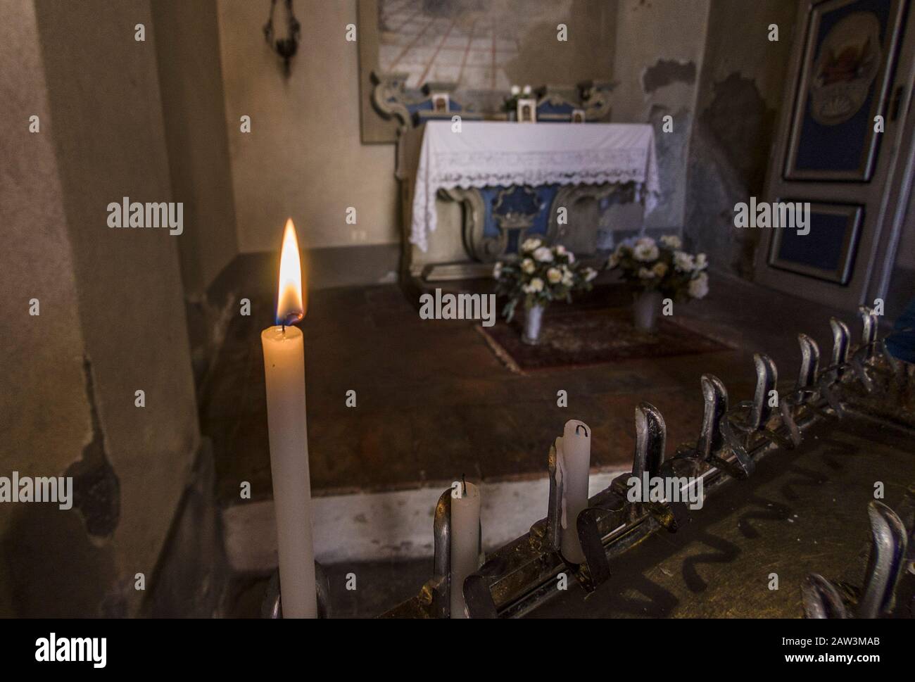 Burning candles inside a church Stock Photo