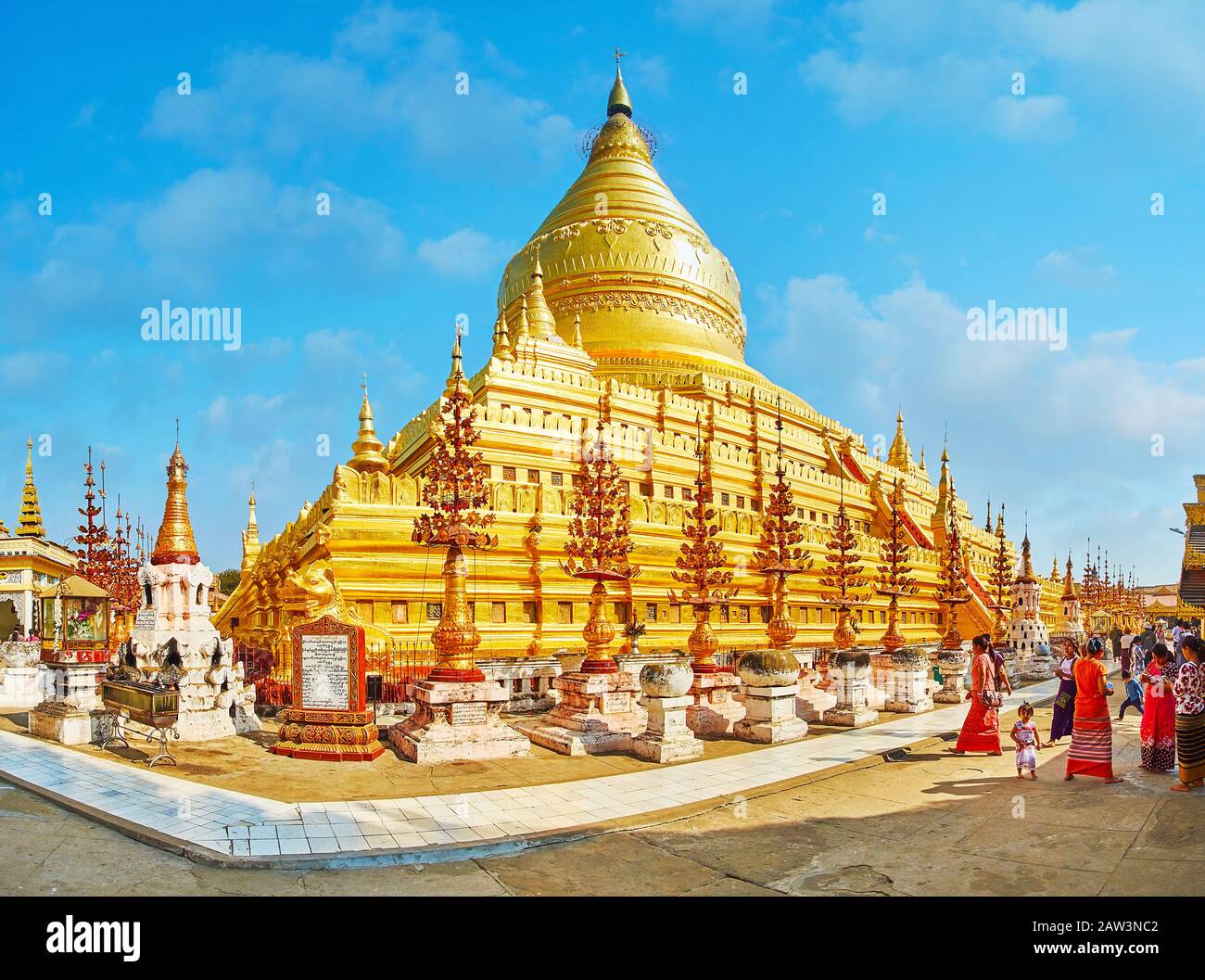BAGAN, MYANMAR - FEBRUARY 25, 2018: The main stupa of Shwezigon Pagoda, decorated with carved spires with golden flowers and bells, on February 25 in Stock Photo