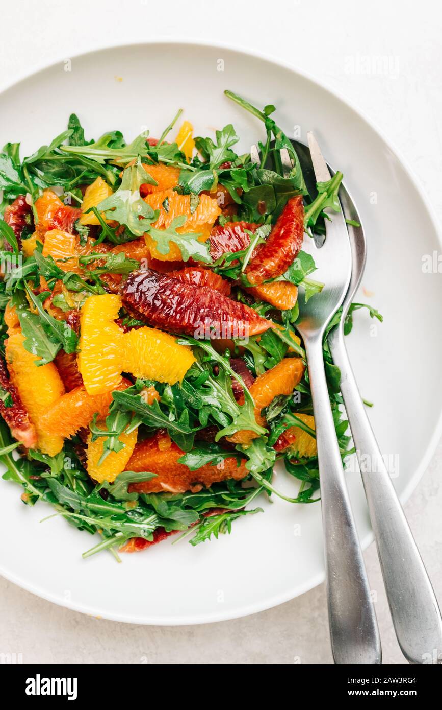 Citrus arugula salad with blood orange, cara cara, and naval oranges Stock Photo