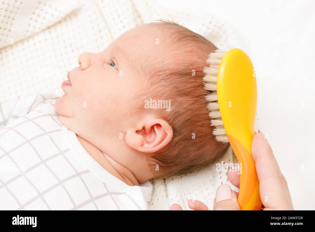 Mother brushing hair of her newborn baby using soft hairbrush to stimulate  infant's hair follicles and increase scalp blood flow for healthy hair grow  Stock Photo - Alamy