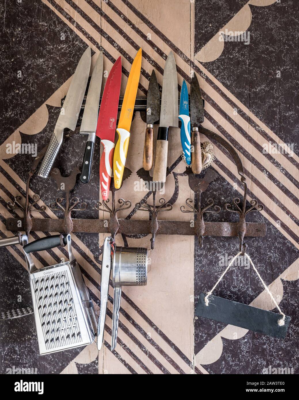 Cooking utensils on wall Stock Photo