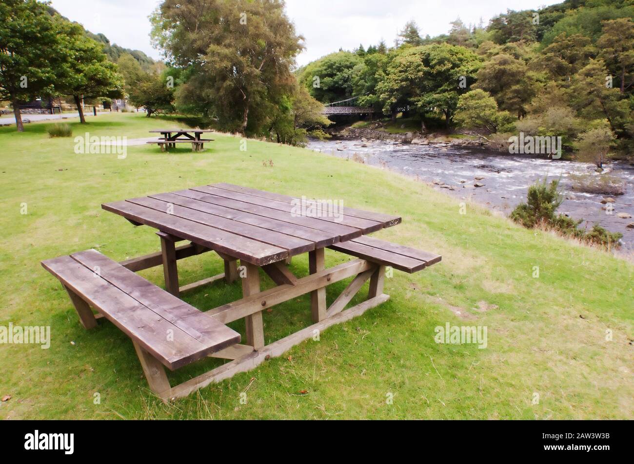Wooden picnic benches in the Elan Valley Village, Powys, Wales Stock Photo