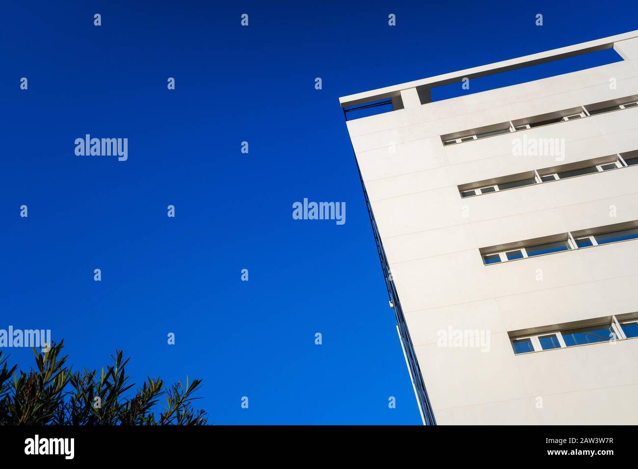 Modern minimalist building with smooth walls and square windows, with ...