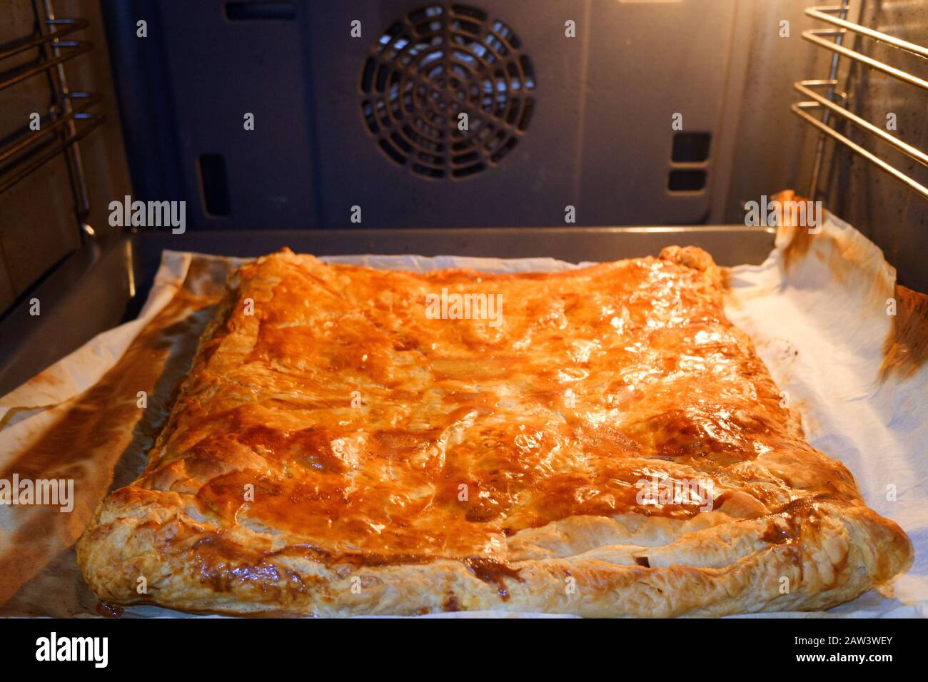 Homemade pie cooking inside an oven with puff pastry Stock Photo Alamy