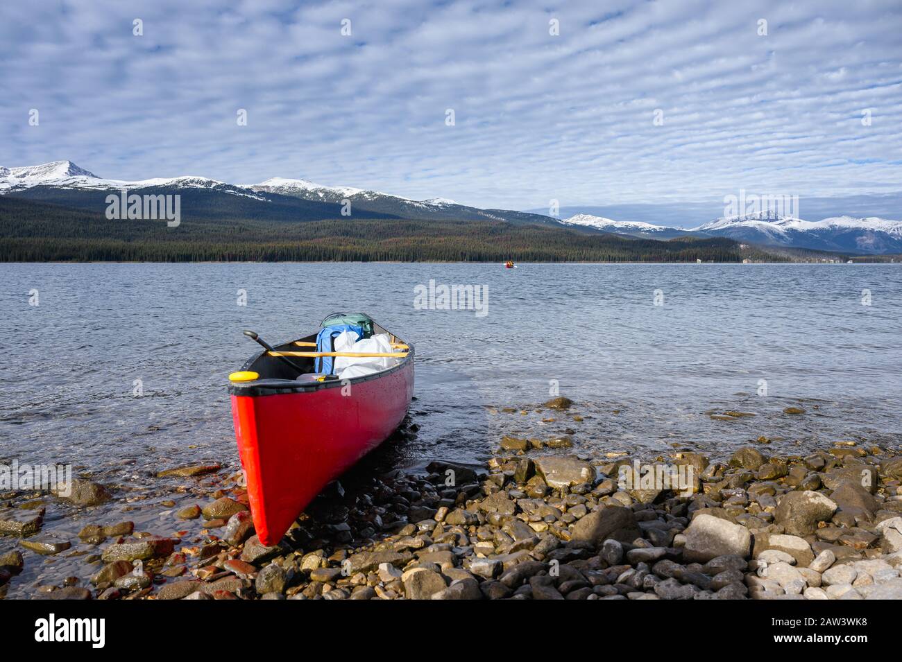Red canoe anchored on coastline in Maligne lake at Jasper national park, Canada Stock Photo