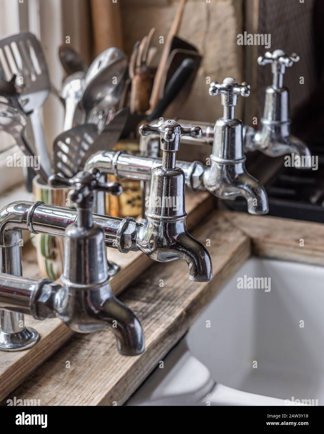 Silver taps over kitchen sink Stock Photo