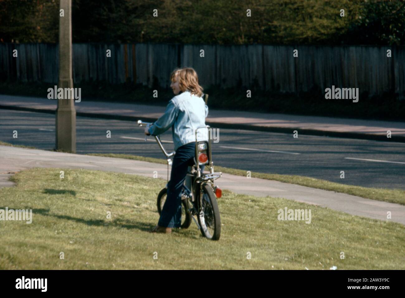 An 11 year old boy riding his new an American export Raleigh Chopper bike in 1973 in the suburbs of London UK. Stock Photo