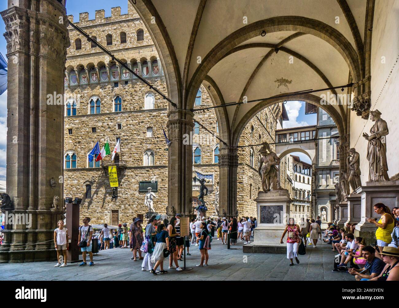Palazzo Vecchio seen from the arches of Loggia dei Lanzi at  Piazza della Signoria, Florence, Tuscany, Italy Stock Photo