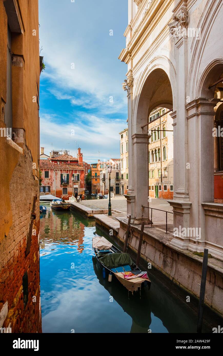 View of Rio della Frescada canal and Castelfrote area with its colorful houses just behind the famous Scuola Grande di San Rocco (Great School of St R Stock Photo